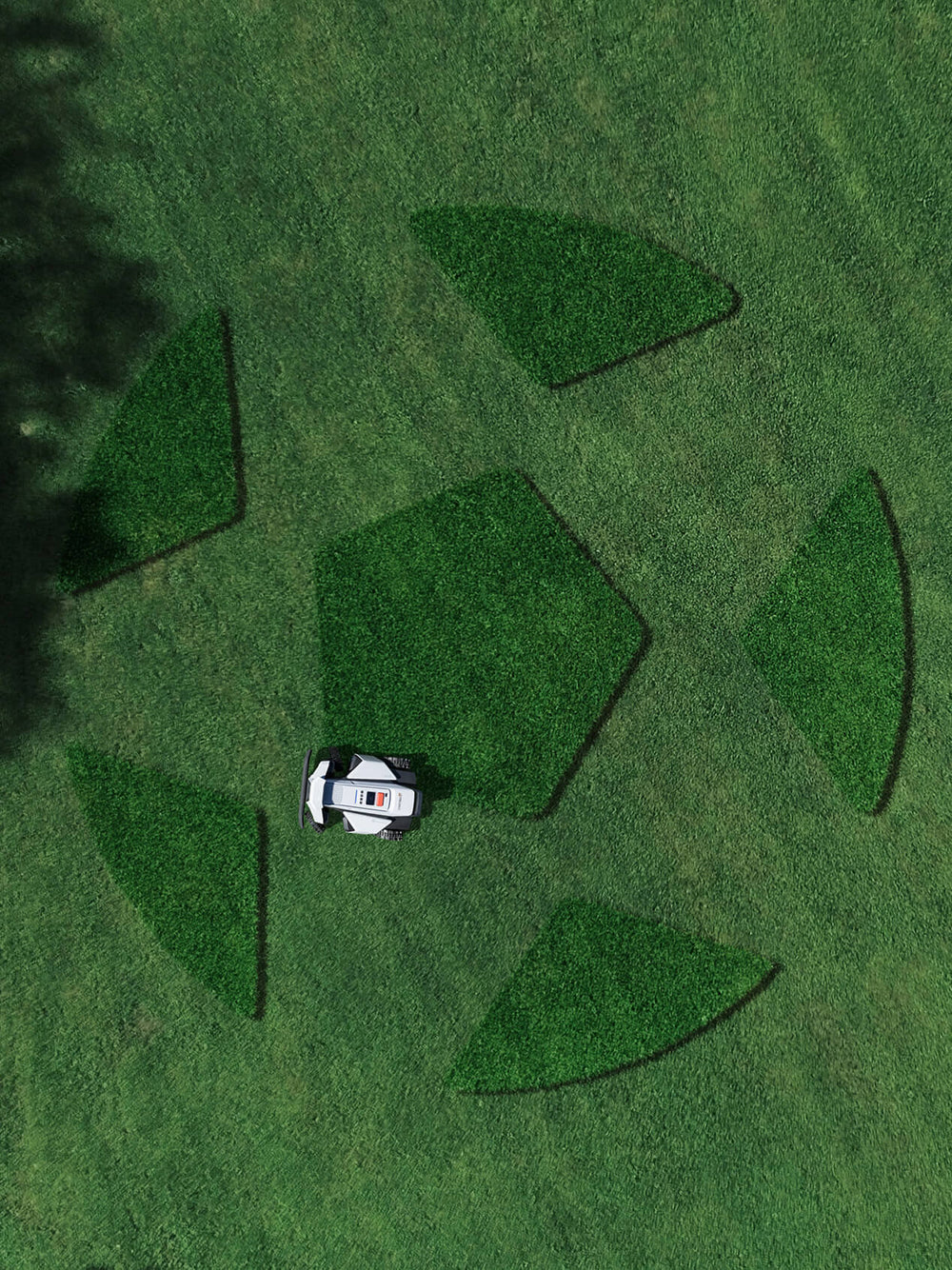 Segway Navimow i105E robotmaaier maait een voetbal op het gras.